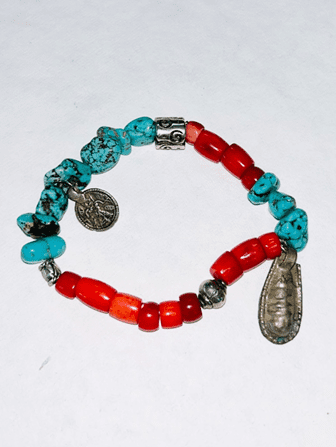 handmade bracelet with turquoise stones, coral beads, and sterling silver charms inspired by Midwest prairie and Southwest desert landscapes