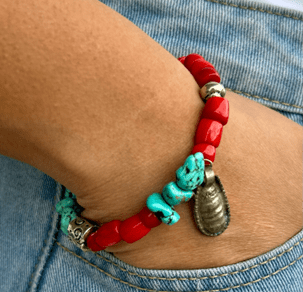 handmade bracelet with turquoise stones, coral beads, and sterling silver charms inspired by Midwest prairie and Southwest desert landscapes