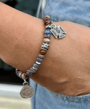 purple aragonite Om Firebird bracelet with symbolic charms