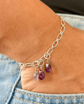 sterling silver amethyst charm bracelet with three dangling amethyst stones