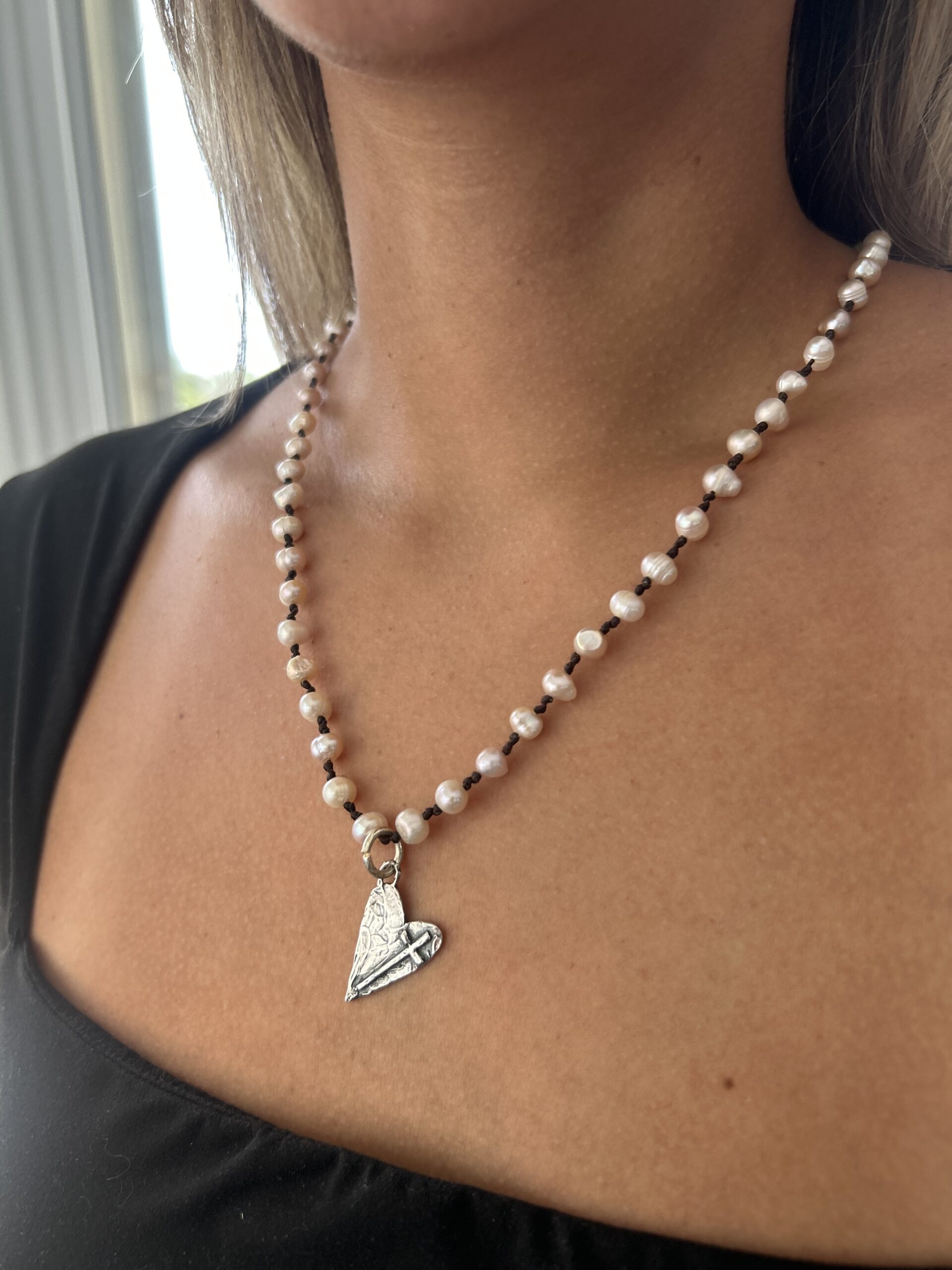 pearl necklace with hand-hammered sterling silver heart and small cross