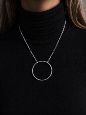 The Ring necklace centered on a two-inch hand-hammered sterling silver circle